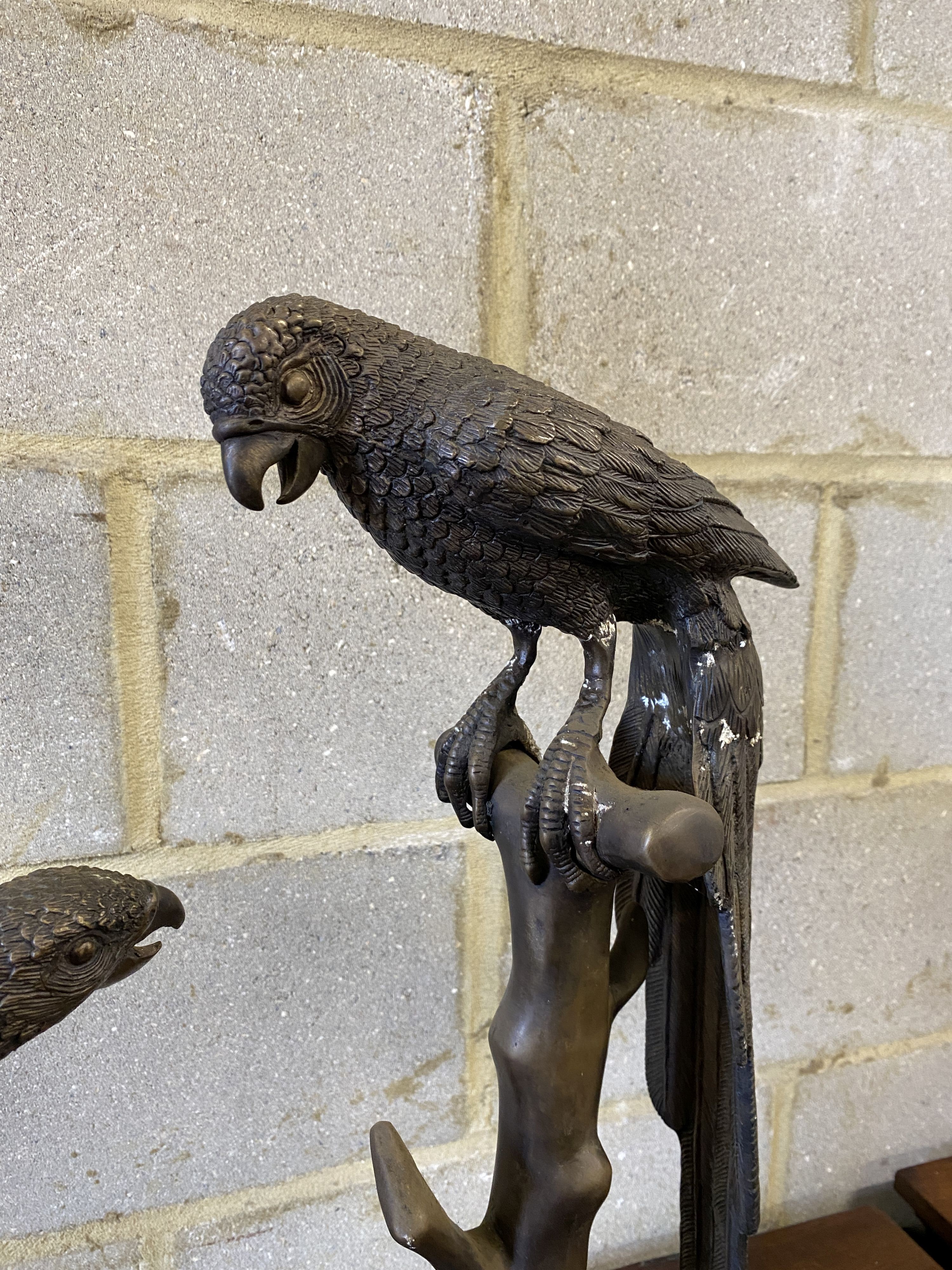 A pair of patinated cast metal macaws, larger height 88cm